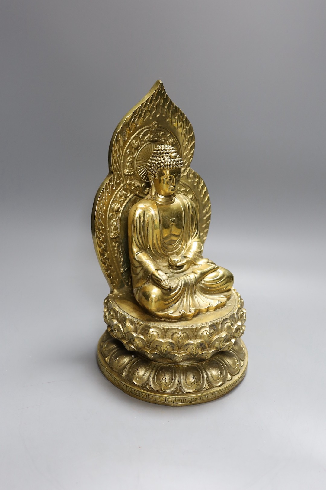 A Chinese built metal Buddha - 29cm high, a bronze Chinese lobed dish, together with a Tibetan teapot